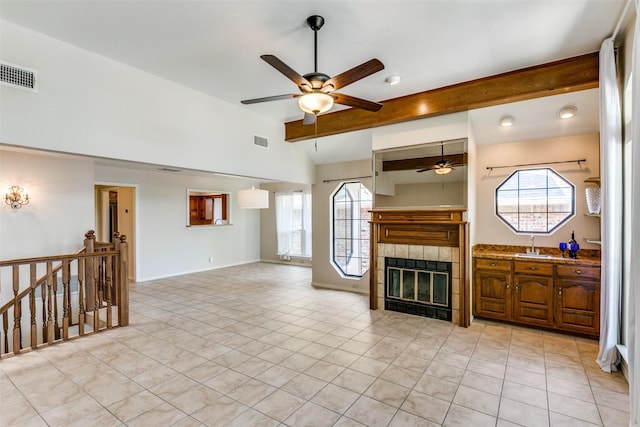 5915 Volunteer Pl, Rockwall, TX 75032 - unfurnished living room featuring ceiling fan, healthy amount of natural light, light tile patterned flooring, and a tile fireplace