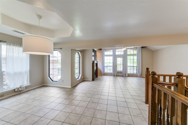 5915 Volunteer Pl, Rockwall, TX 75032 - empty room with light tile patterned floors, baseboards, and a tray ceiling