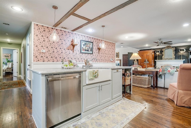 kitchen with open floor plan, dark wood finished floors, wallpapered walls, light stone counters, and dishwasher