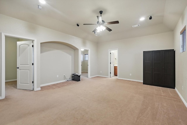 unfurnished bedroom with visible vents, baseboards, ensuite bathroom, and light colored carpet