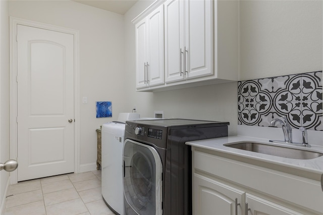 749 Lazy Brooke Dr, Rockwall, TX 75087 - washroom featuring washer and dryer, cabinet space, a sink, and light tile patterned floors