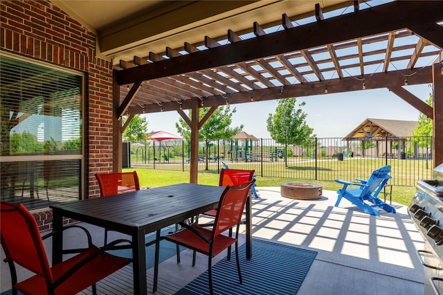 749 Lazy Brooke Dr, Rockwall, TX 75087 - view of patio / terrace with playground community, a pergola, fence, outdoor dining space, and an outdoor fire pit