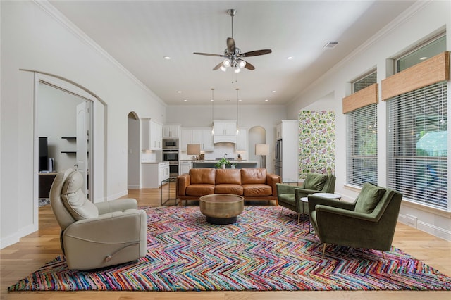 749 Lazy Brooke Dr, Rockwall, TX 75087 - living area featuring ceiling fan, arched walkways, ornamental molding, and light wood-style floors