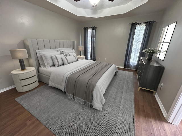 3308 Omega Dr, Tyler, TX 75701 - bedroom featuring wood finished floors, multiple windows, and a raised ceiling