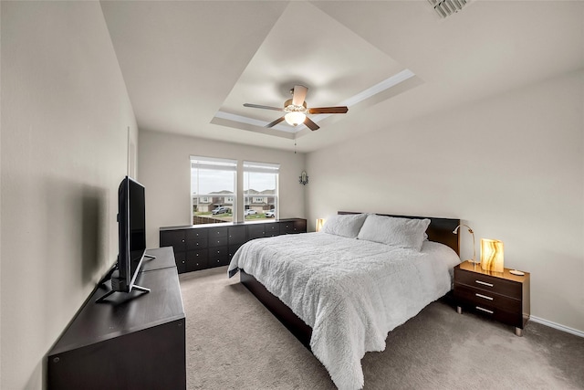 1718 Ackerly Dr, Forney, TX 75126 - bedroom featuring a tray ceiling, light carpet, a ceiling fan, and baseboards