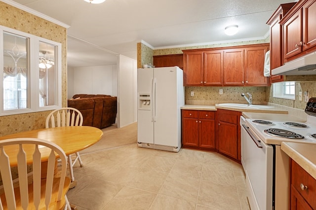 kitchen featuring under cabinet range hood, light countertops, white appliances, and a sink