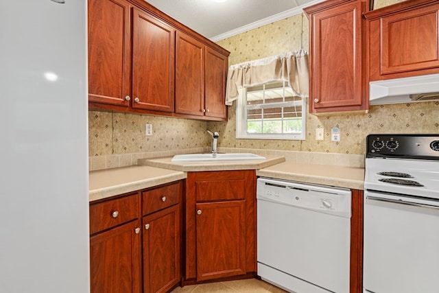 kitchen featuring a sink, white appliances, crown molding, light countertops, and under cabinet range hood