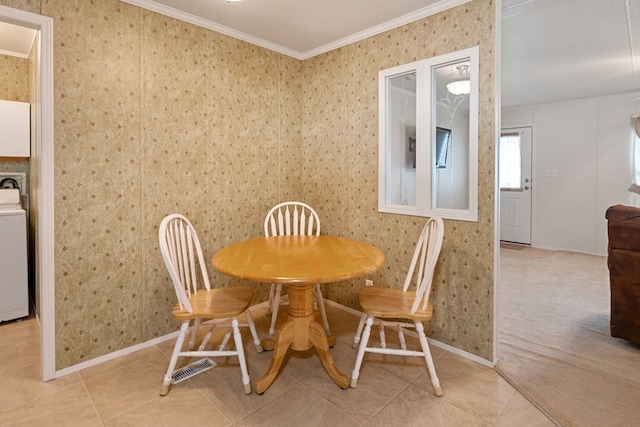 dining area featuring baseboards, wallpapered walls, washer / clothes dryer, crown molding, and light tile patterned floors