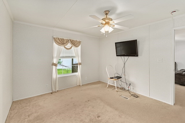 interior space featuring ceiling fan, baseboards, carpet, and ornamental molding