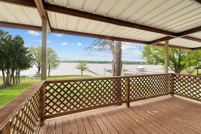 wooden terrace featuring a water view