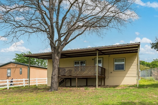 back of house featuring metal roof, a yard, and fence