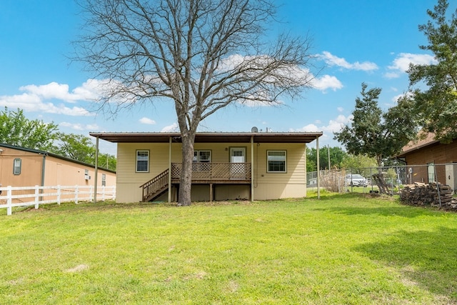 back of house with fence, stairs, and a yard