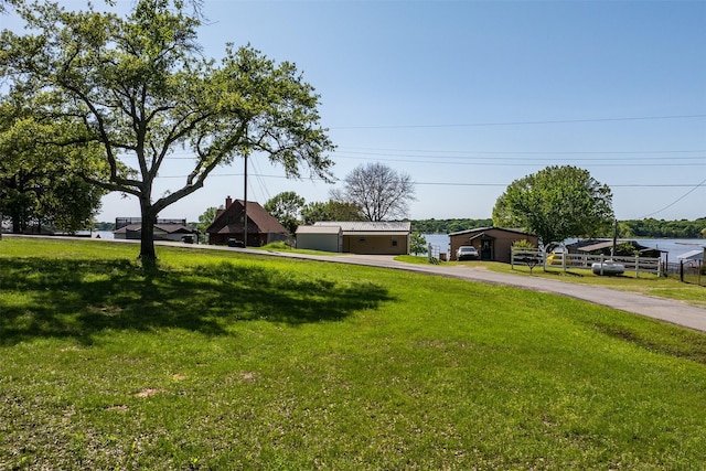 view of front facade featuring a front lawn and aphalt driveway