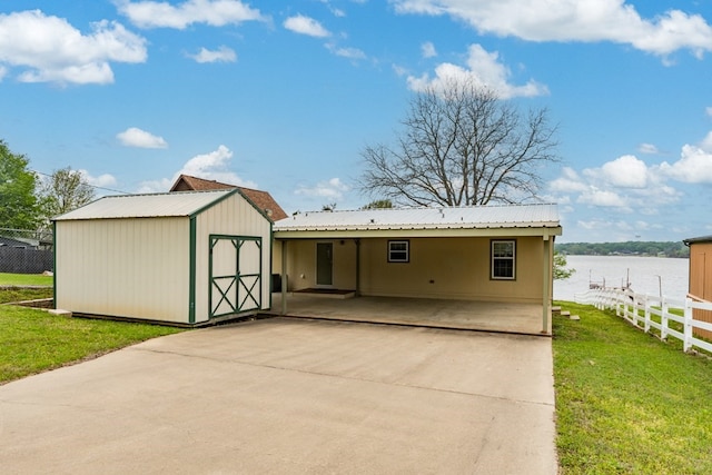 exterior space with fence, an outbuilding, a yard, and a shed