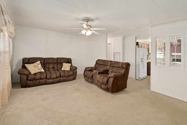 living room featuring light colored carpet and a ceiling fan