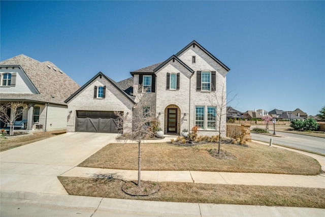 1645 Lilac Ln, Celina, TX 75009 - french provincial home featuring driveway, a garage, and brick siding