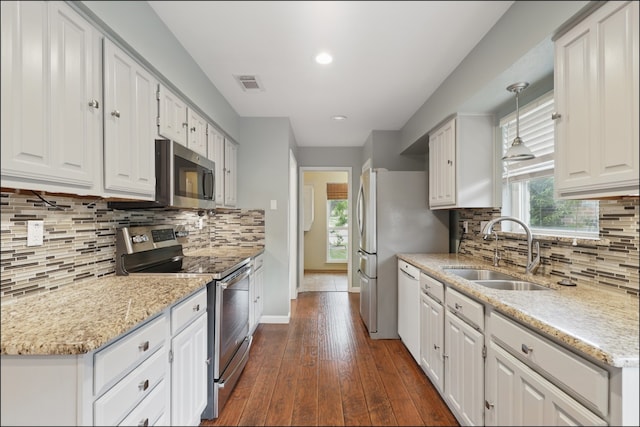 kitchen with white cabinetry, appliances with stainless steel finishes, a sink, and visible vents