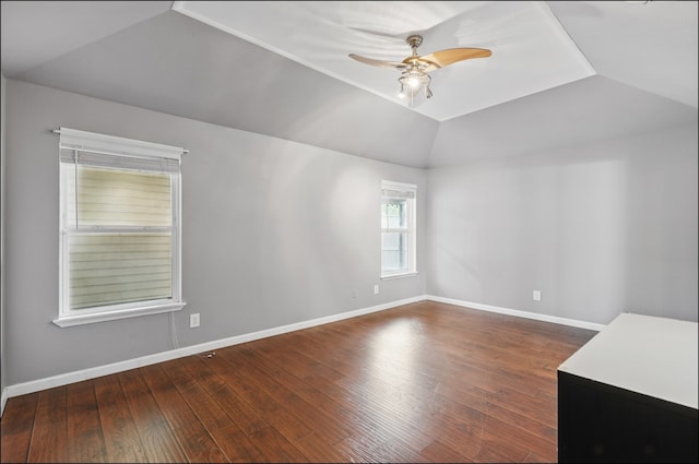 empty room with lofted ceiling, a ceiling fan, wood finished floors, and baseboards