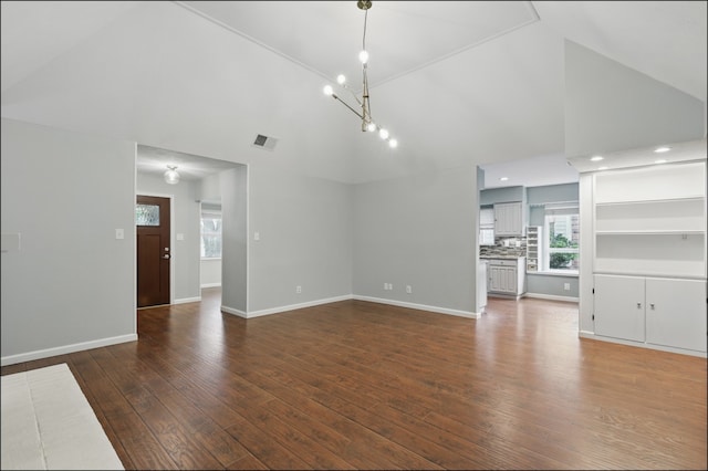 unfurnished living room featuring an inviting chandelier, visible vents, dark wood-type flooring, baseboards, and high vaulted ceiling