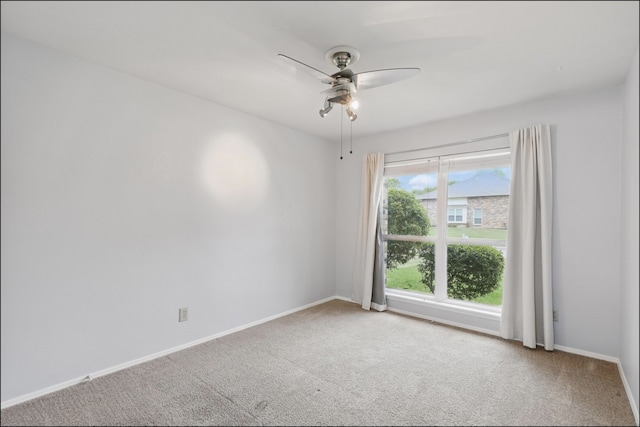unfurnished room with baseboards, a ceiling fan, and carpet flooring