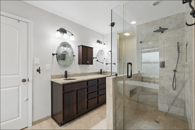full bathroom with a sink, a shower stall, and double vanity
