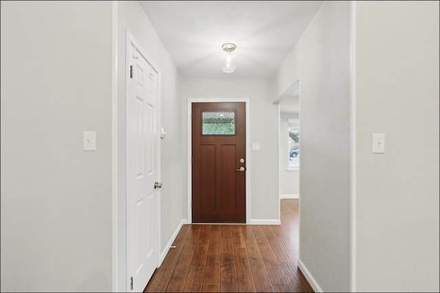 foyer with baseboards and dark wood-style floors