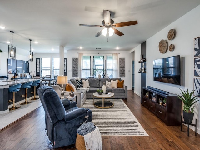 living area with recessed lighting, wood finished floors, baseboards, and ceiling fan