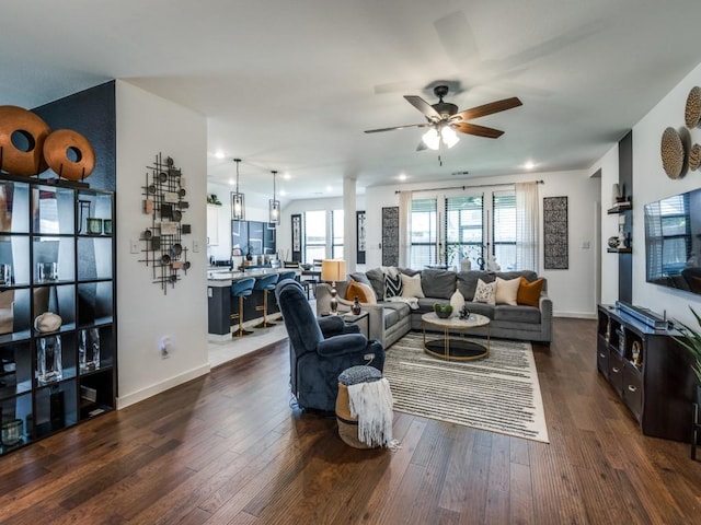 living room featuring baseboards, recessed lighting, ceiling fan, and dark wood finished floors