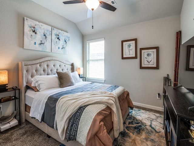 carpeted bedroom with vaulted ceiling, baseboards, and ceiling fan