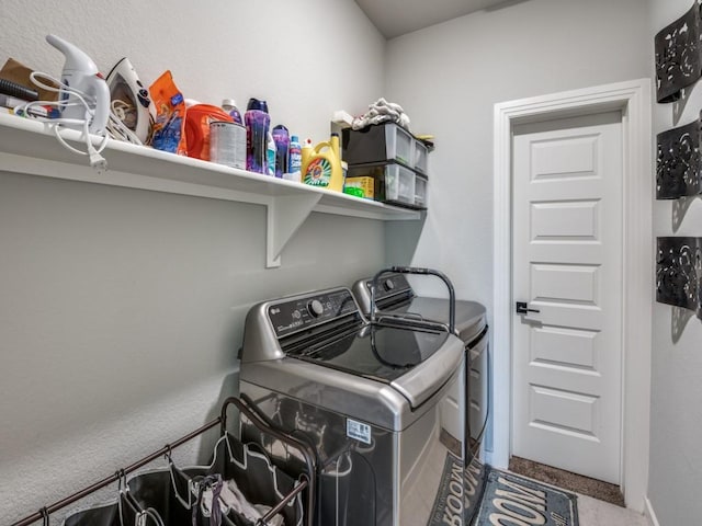 washroom featuring carpet floors, washing machine and clothes dryer, and laundry area