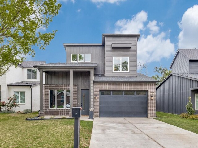 view of front facade featuring a front lawn, a garage, brick siding, and concrete driveway
