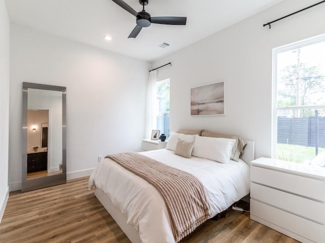 bedroom featuring baseboards, visible vents, wood finished floors, and recessed lighting