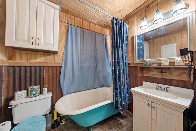 bathroom featuring toilet, vanity, and wooden walls