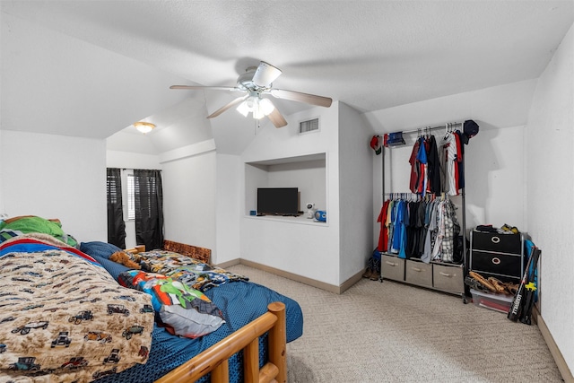 carpeted bedroom featuring baseboards, a textured ceiling, lofted ceiling, and visible vents