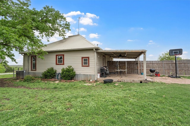 back of house with cooling unit, a wooden deck, fence, and a yard