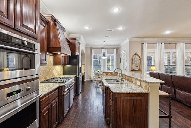 4513 Cherokee Dr, Mckinney, TX 75072 - kitchen with crown molding, dark wood finished floors, a breakfast bar, a sink, and decorative backsplash