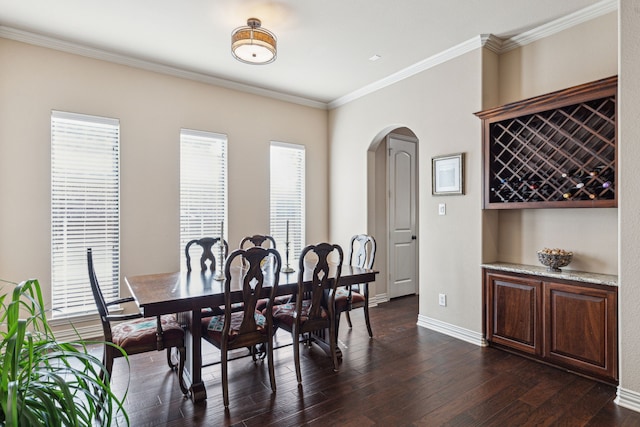 4513 Cherokee Dr, Mckinney, TX 75072 - dining area featuring dark wood-style flooring, baseboards, arched walkways, and crown molding