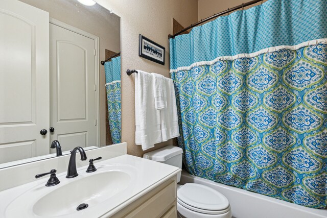 4513 Cherokee Dr, Mckinney, TX 75072 - bathroom featuring toilet, shower / bathtub combination with curtain, vanity, and a textured wall