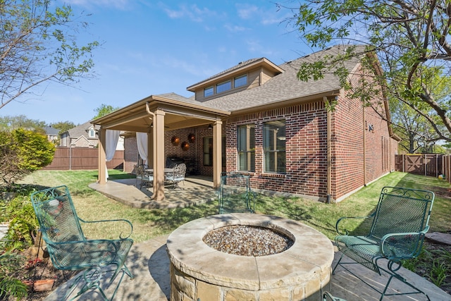 4513 Cherokee Dr, Mckinney, TX 75072 - back of house featuring a patio, brick siding, a fenced backyard, and an outdoor fire pit