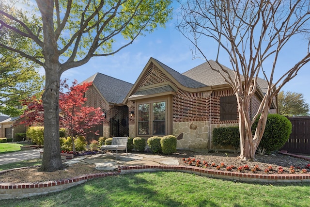 4513 Cherokee Dr, Mckinney, TX 75072 - view of front of home featuring brick siding, fence, stone siding, a front lawn, and a shingled roof