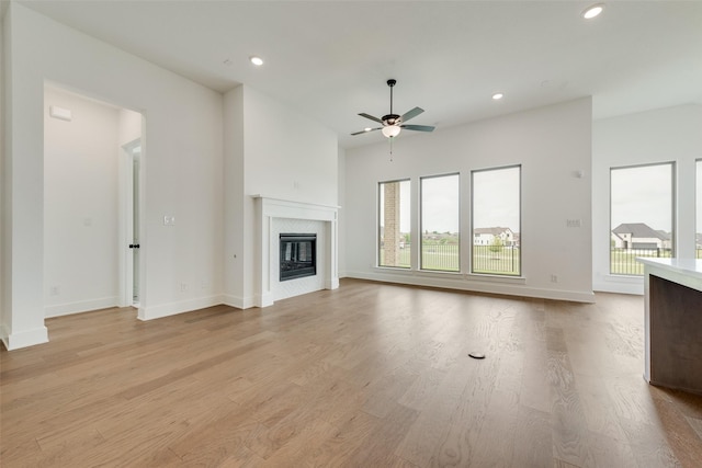 unfurnished living room featuring a ceiling fan, recessed lighting, and a wealth of natural light
