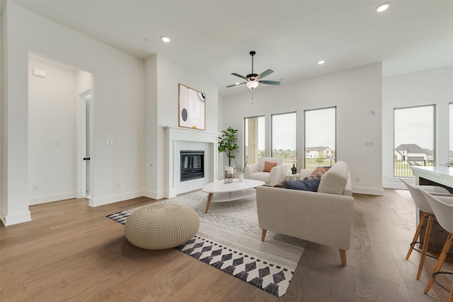 living room featuring a healthy amount of sunlight, baseboards, and recessed lighting