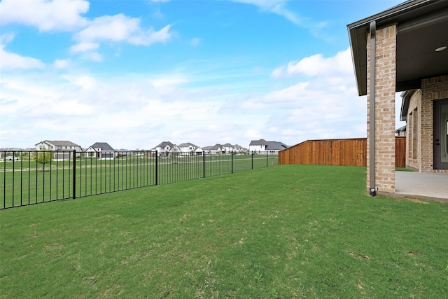 view of yard featuring a residential view and a fenced backyard
