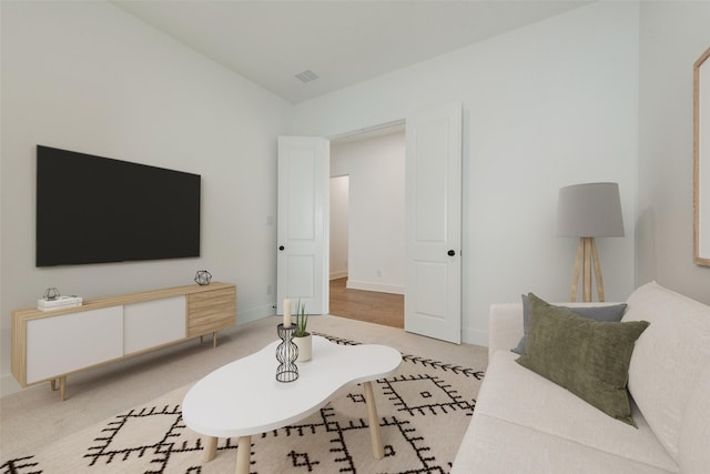 living room featuring visible vents and light colored carpet