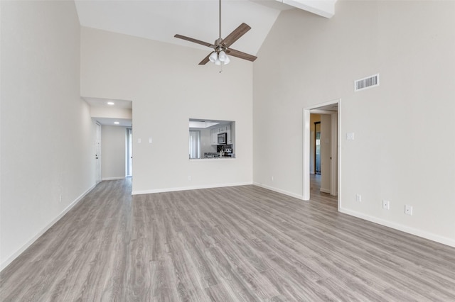 4539 N O Connor Rd Unit 2233, Irving, TX 75062 - unfurnished living room with high vaulted ceiling, a ceiling fan, baseboards, and wood finished floors