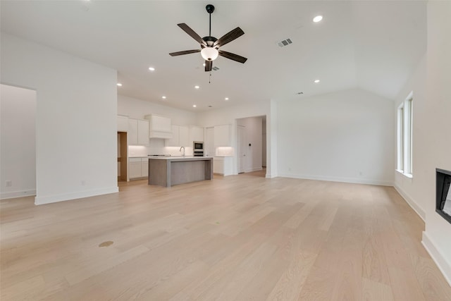1151 Nora Ln, Forney, TX 75126 - unfurnished living room featuring a ceiling fan, a sink, light wood-style floors, baseboards, and recessed lighting