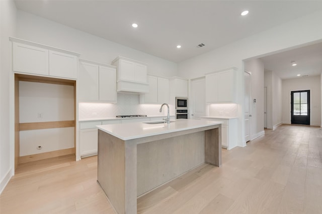 1151 Nora Ln, Forney, TX 75126 - kitchen featuring a sink, oven, stovetop, built in microwave, and tasteful backsplash