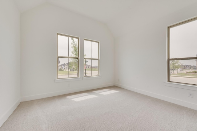 1151 Nora Ln, Forney, TX 75126 - empty room featuring lofted ceiling, light colored carpet, and baseboards