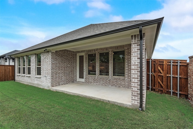 1151 Nora Ln, Forney, TX 75126 - rear view of house featuring brick siding, a patio area, and roof with shingles