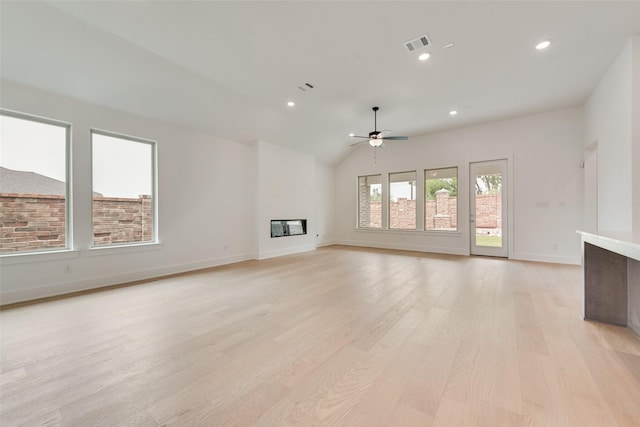 1151 Nora Ln, Forney, TX 75126 - unfurnished living room featuring a ceiling fan, light wood-type flooring, baseboards, a glass covered fireplace, and recessed lighting